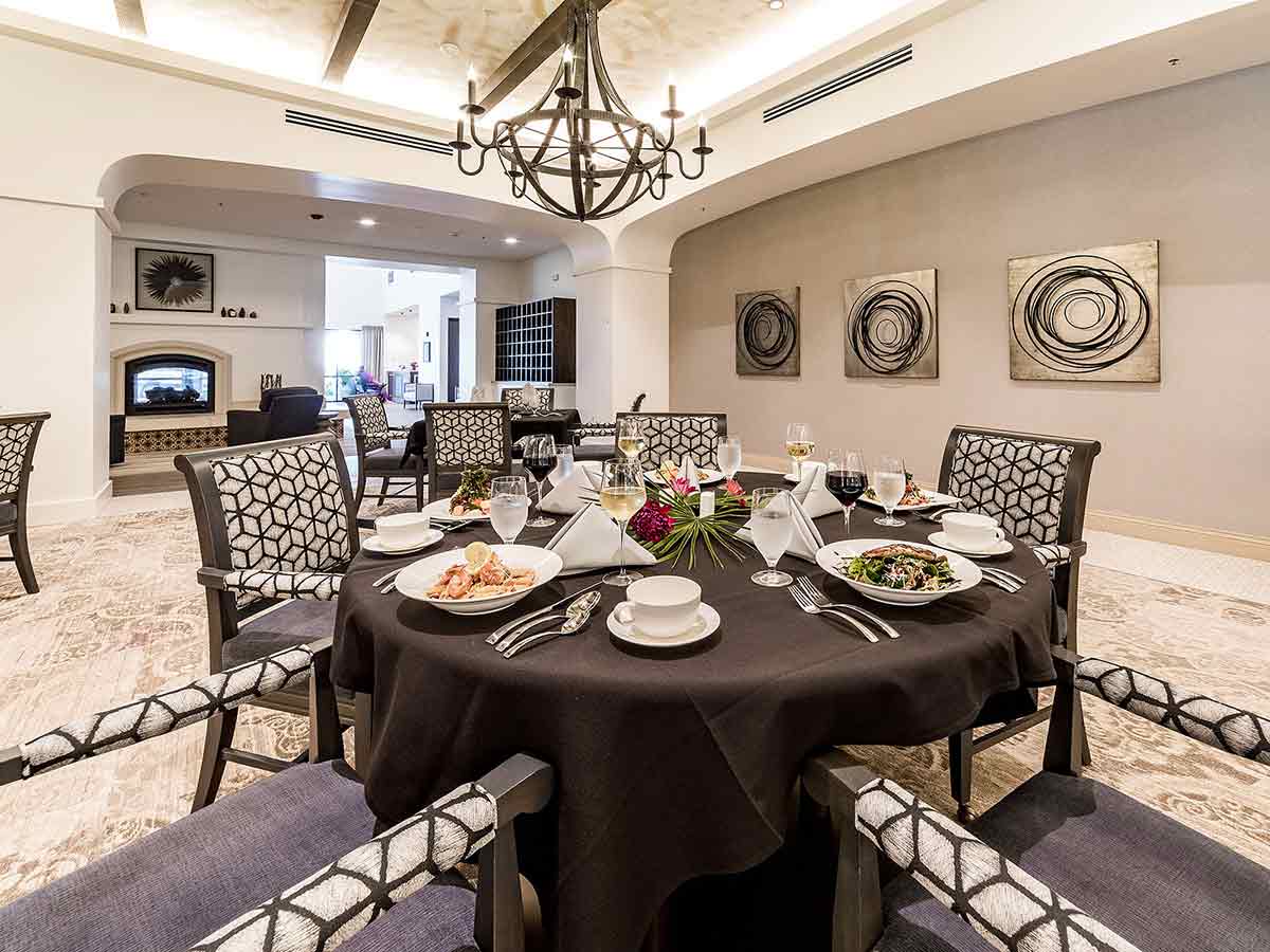 A dining room table at the Villas at Stanford Ranch, set for dinner with fresh chef-prepared meals.