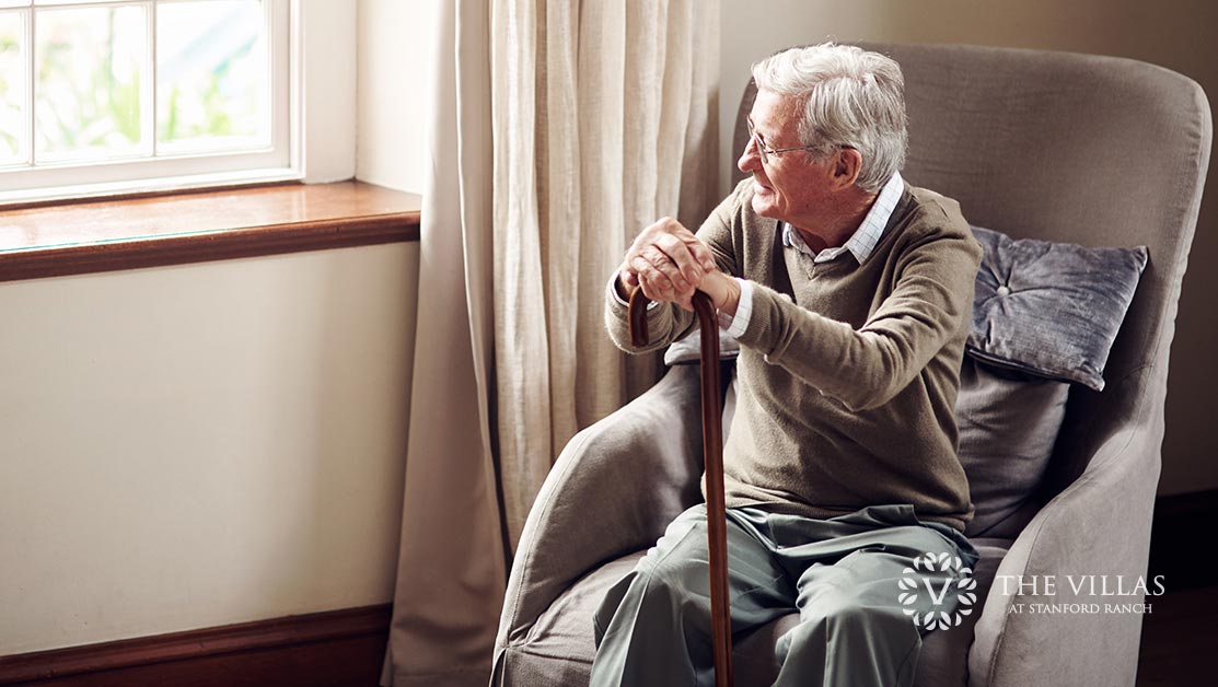 A senior with Alzheimer’s looks out the window. Discover 5 benefits of a memory care facility for Alzheimer’s and dementia patients at The Villas at Stanford Ranch.