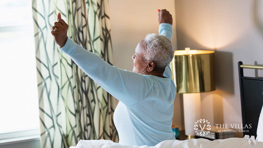 An elderly woman waking up and stretching. Discover sleep tips for seniors.